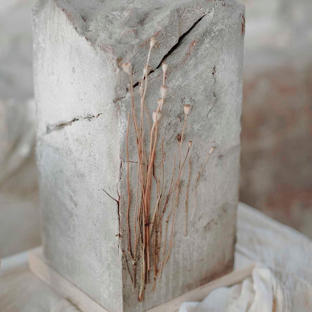 Square tall concrete wedding cake with dried flower stem decor 