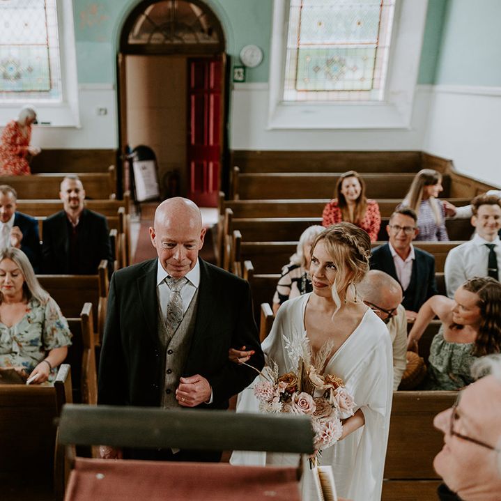 Wedding party watch during ceremony for bride & groom
