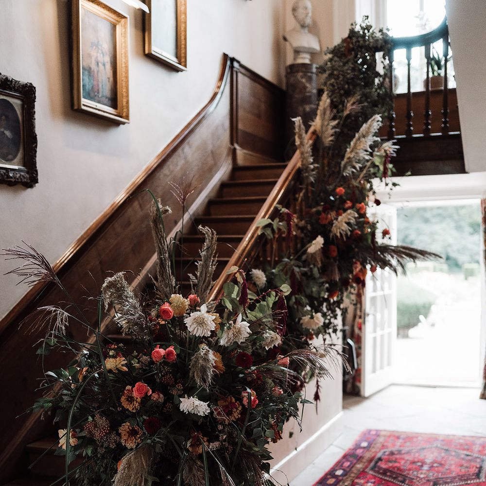 Dried and fresh staircase wedding flower arrangement at Iscoyd Park by Red Floral 