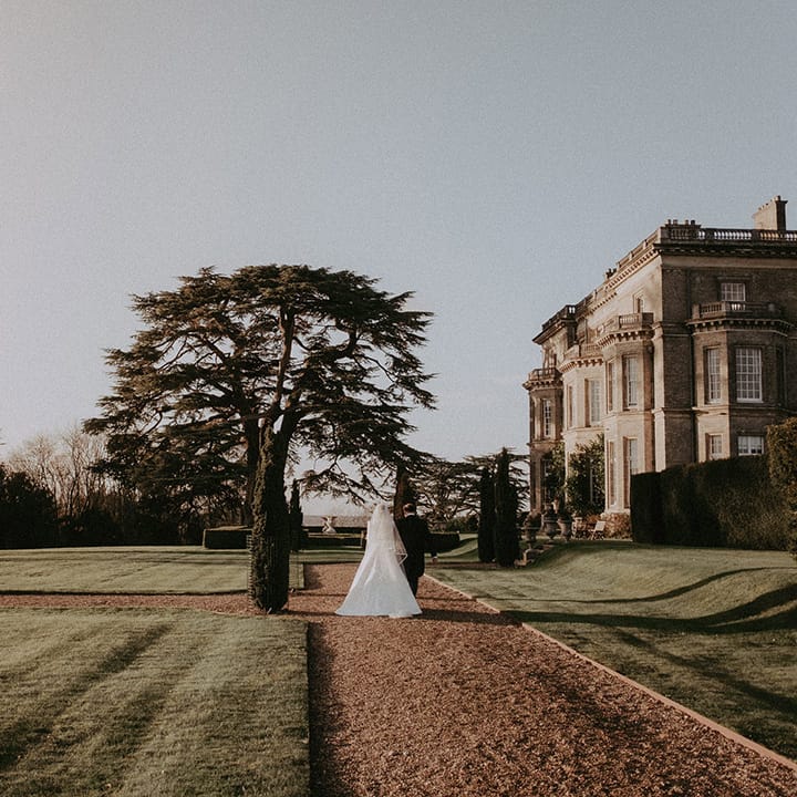 Bride and groom with full length white veil at Hedsor House wedding