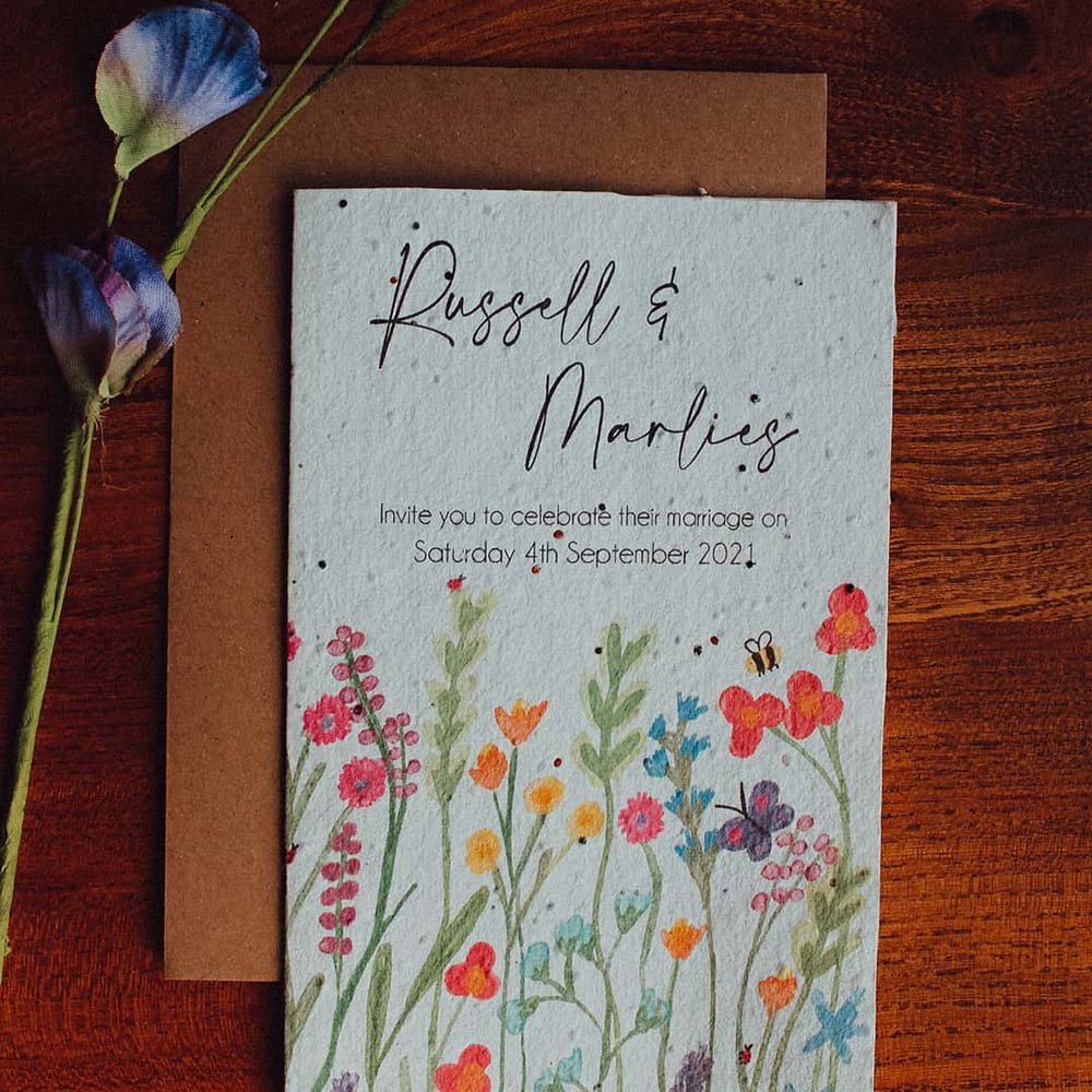 White card wedding invitation with painted colourful flowers and bees 