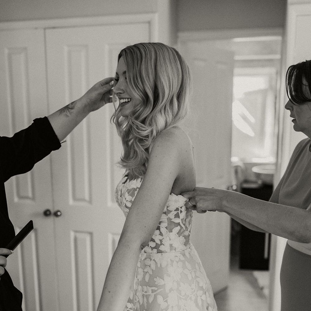 Bridal party help the bride with finishing touches for the big day 