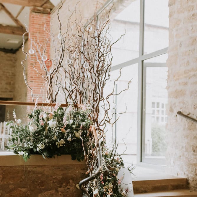 bare twigs and fresh flower wedding reception floral arrangements 