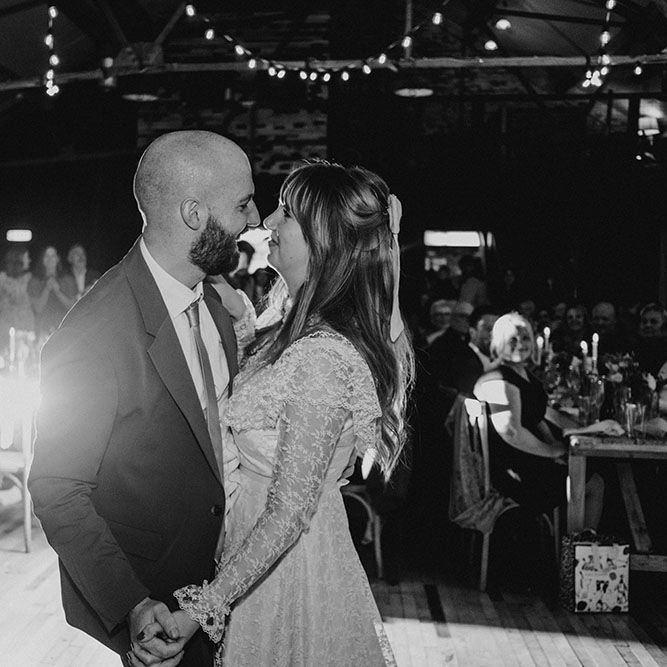 Bride wearing high neck lace gown during first dance with her groom at Scale Liverpool during relaxed reception party