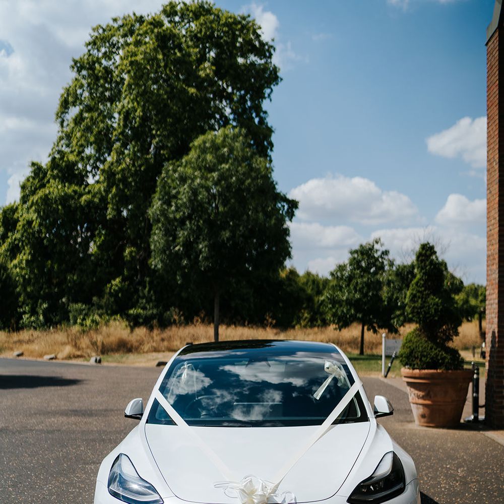 White sports car tied with white ribbon 