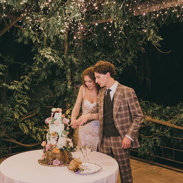 bride and groom cutting their woodland wedding cake 