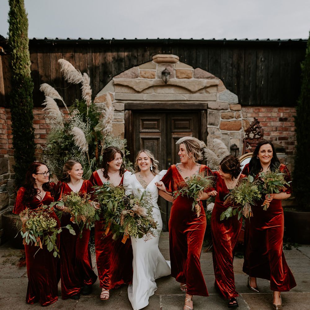 Bridal party wearing orange velvet bridesmaid dresses at the Loughborough wedding 