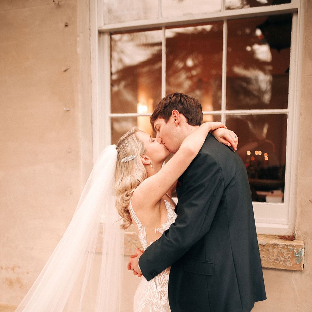 The bride and groom share a kiss for their wedding day to celebrate 
