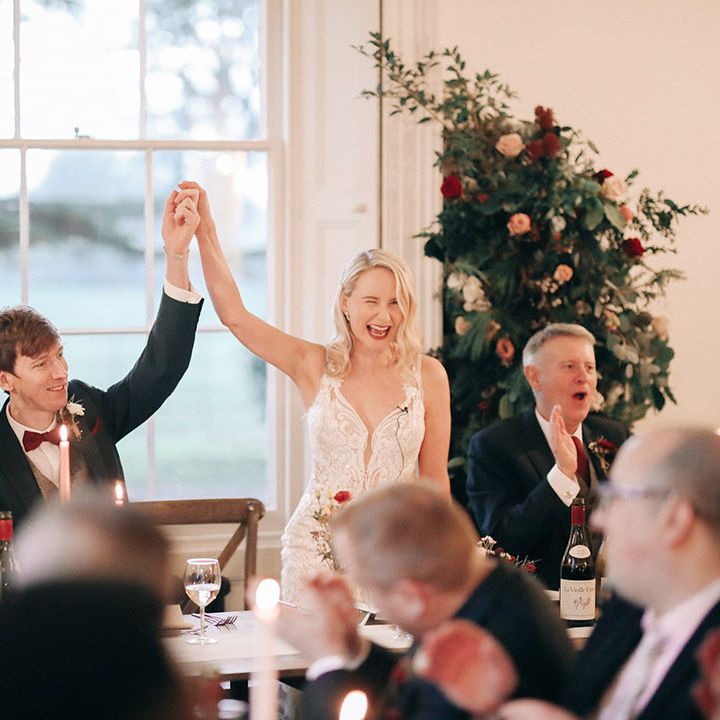 Red and white wedding flower columns decorating the reception space 