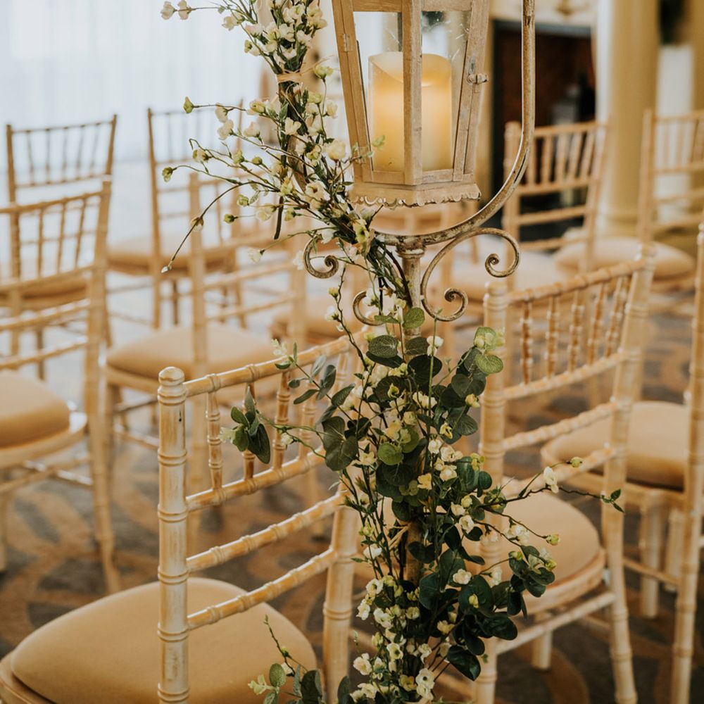 White lantern decorating the aisle at Bishop's Gate Hotel with white wax flower 
