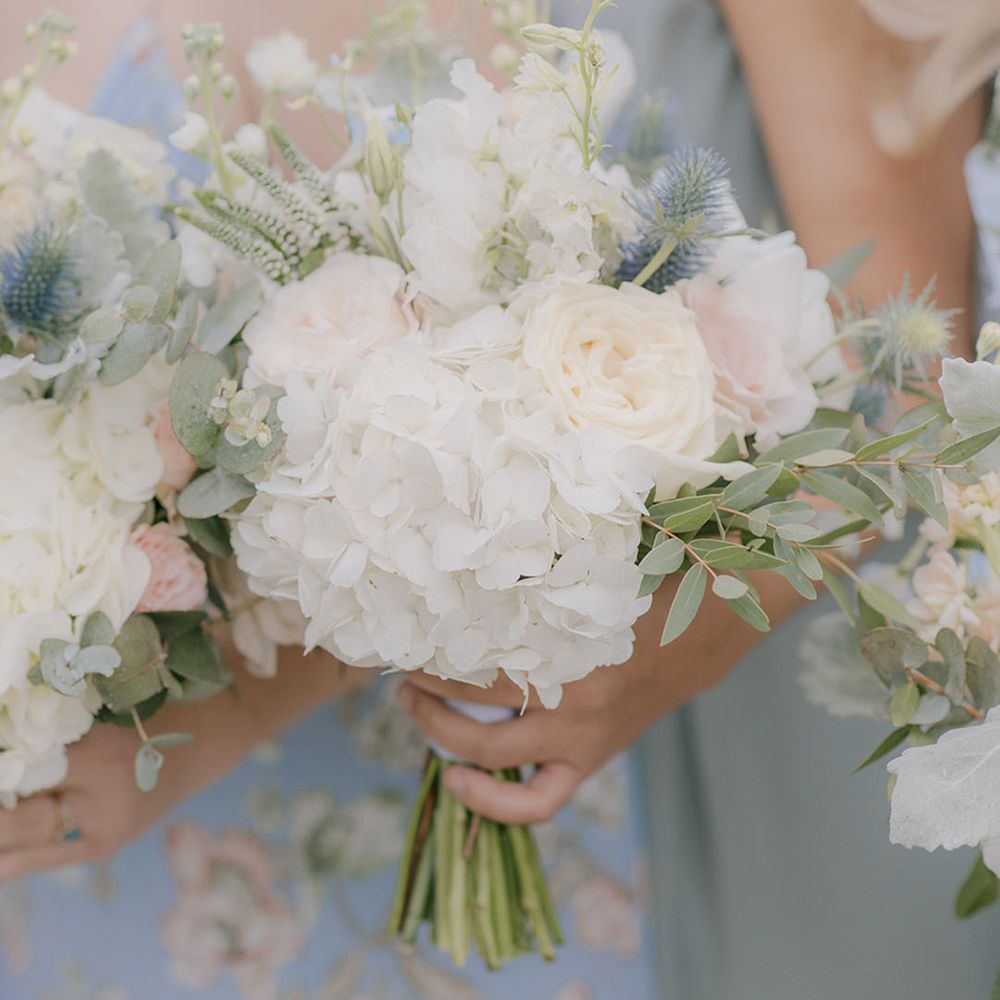 White hydrangeas and roses in bridal bouquet with thistles 