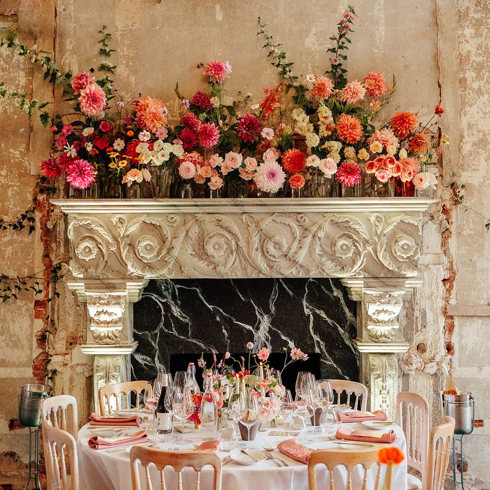Pink wedding theme with pink wedding flowers on the fireplace and the tablescapes 
