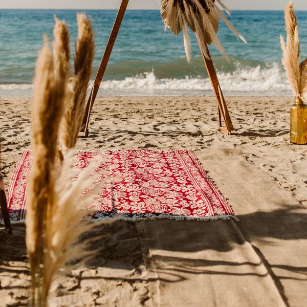 Boho beach wedding in Crete with triangle altar structure and pampas grass decor