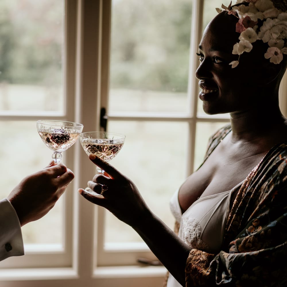Bride and groom toasting on the wedding morning with coupe glasses 