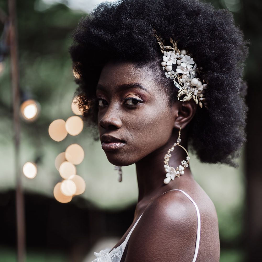 Black bride with afro hair wearing hoop earrings and matching hair slide bridal accessories 