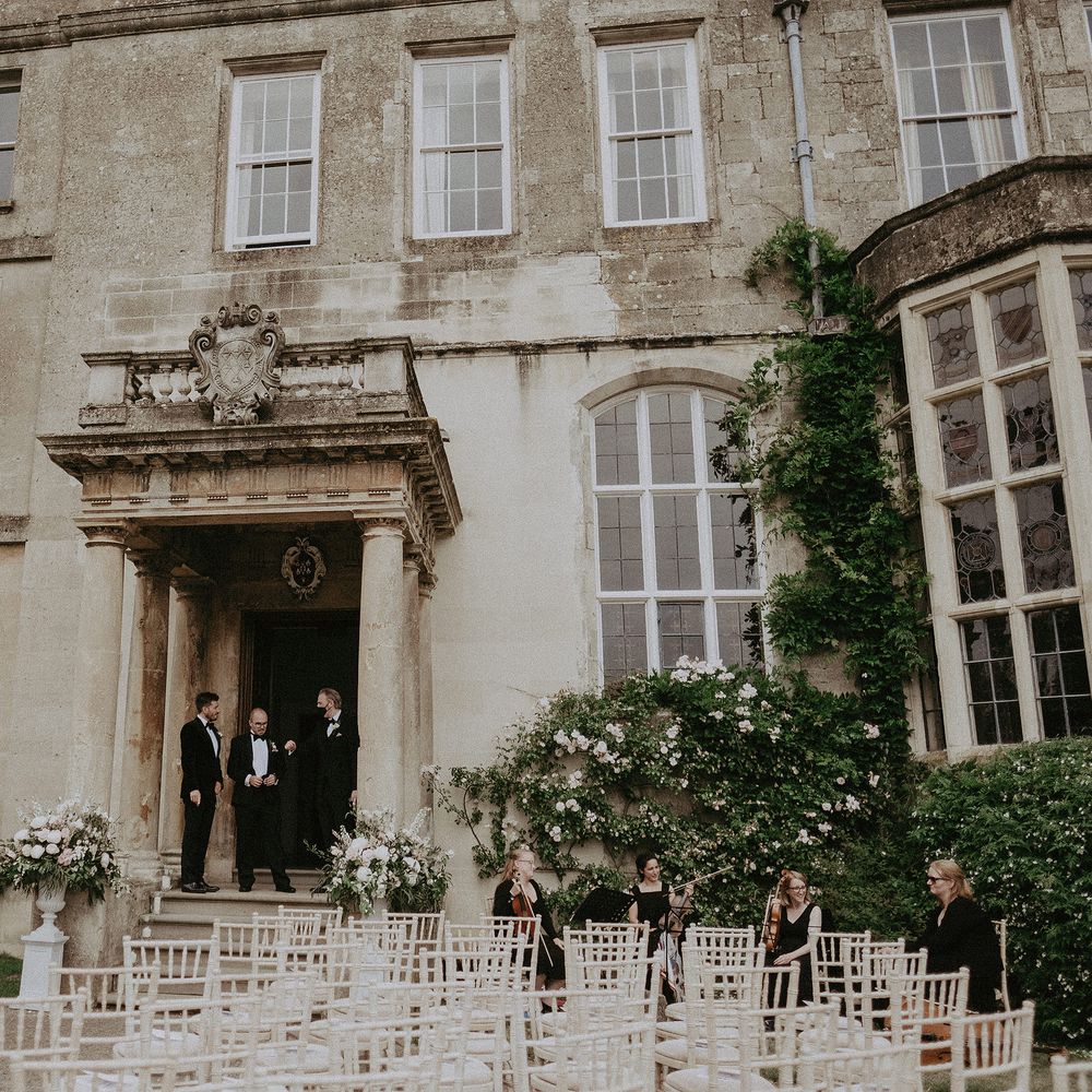 Elmore Court ready for wedding ceremony with chairs lining outdoor aisle in front of large doorway and historic building