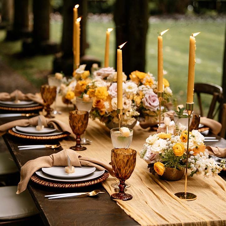 Yellow taper candles, wedding flowers and table runner for honey yellow wedding inspiration