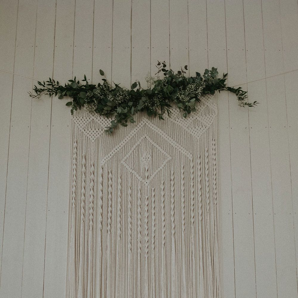 Large macrame hanging with green foliage top for Isle of Wight wedding with macrame wedding decor