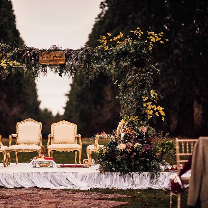 Unique flower arch with a pop of yellow at Indian wedding at Minley Manor