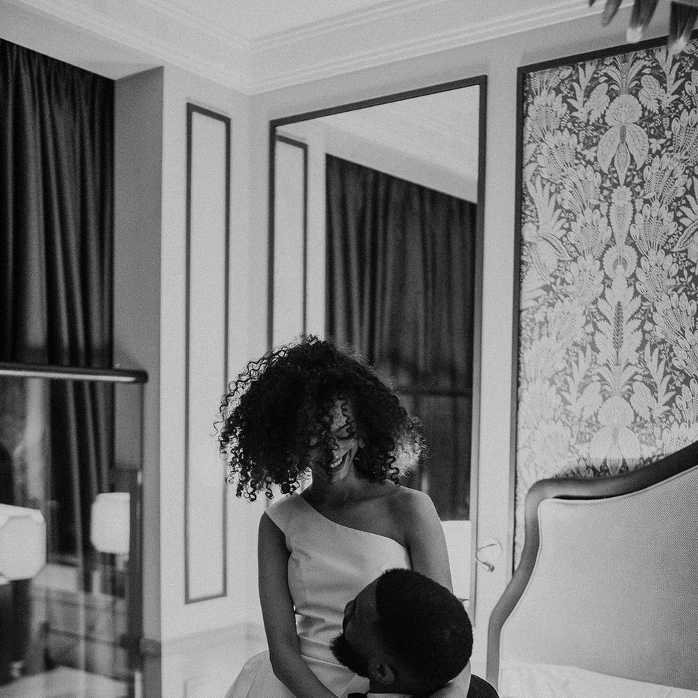 Black bride with naturally curly hair wearing a one shoulder wedding dress at Mayfair Townhouse 