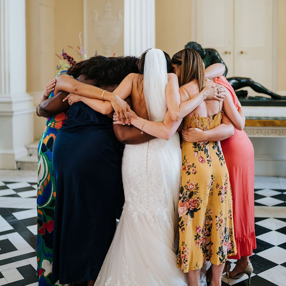 Bride hugs her A Capella group after wedding ceremony