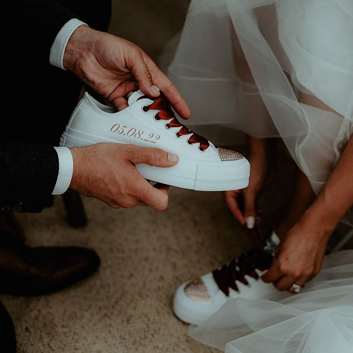 Personalised wedding shoes with the wedding date, orange laces and a bejewelled toe 
