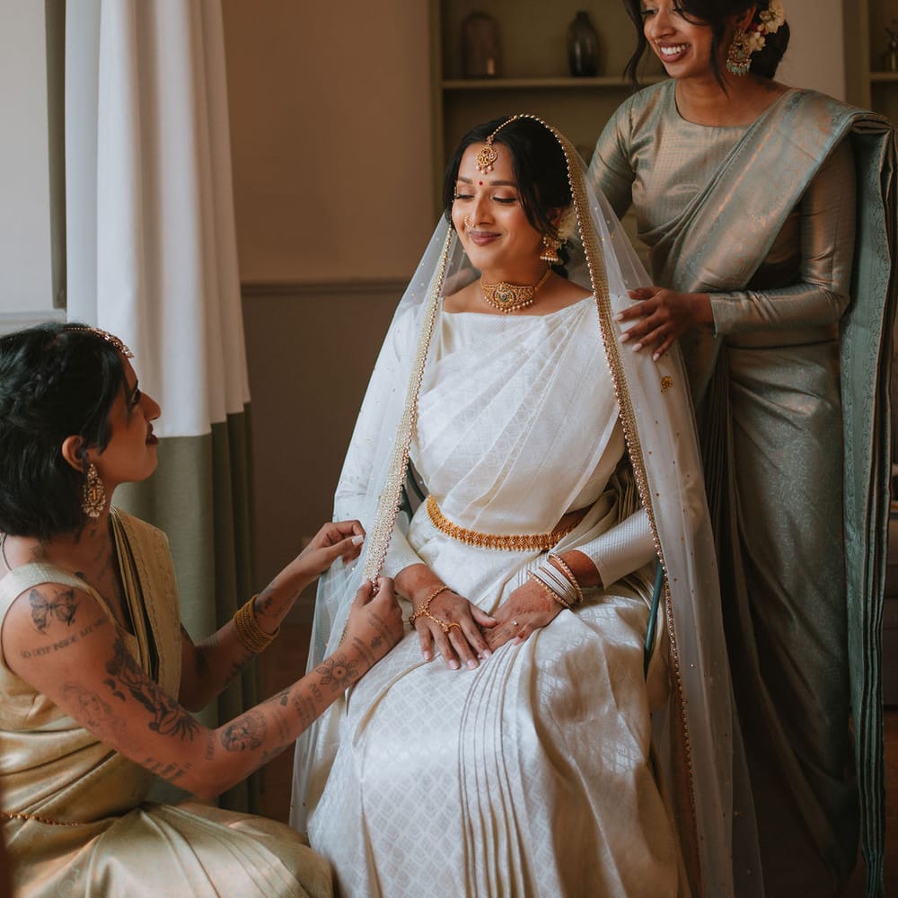 Morning of the wedding with South Asian bride in a cream and gold lehenga 