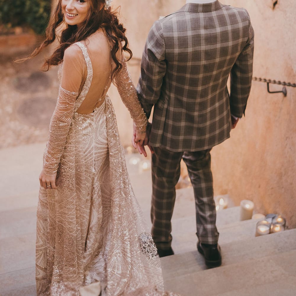 bride in a gold wedding dress and groom in a grey check suit at their Carmen de los Mártires Spanish wedding venue