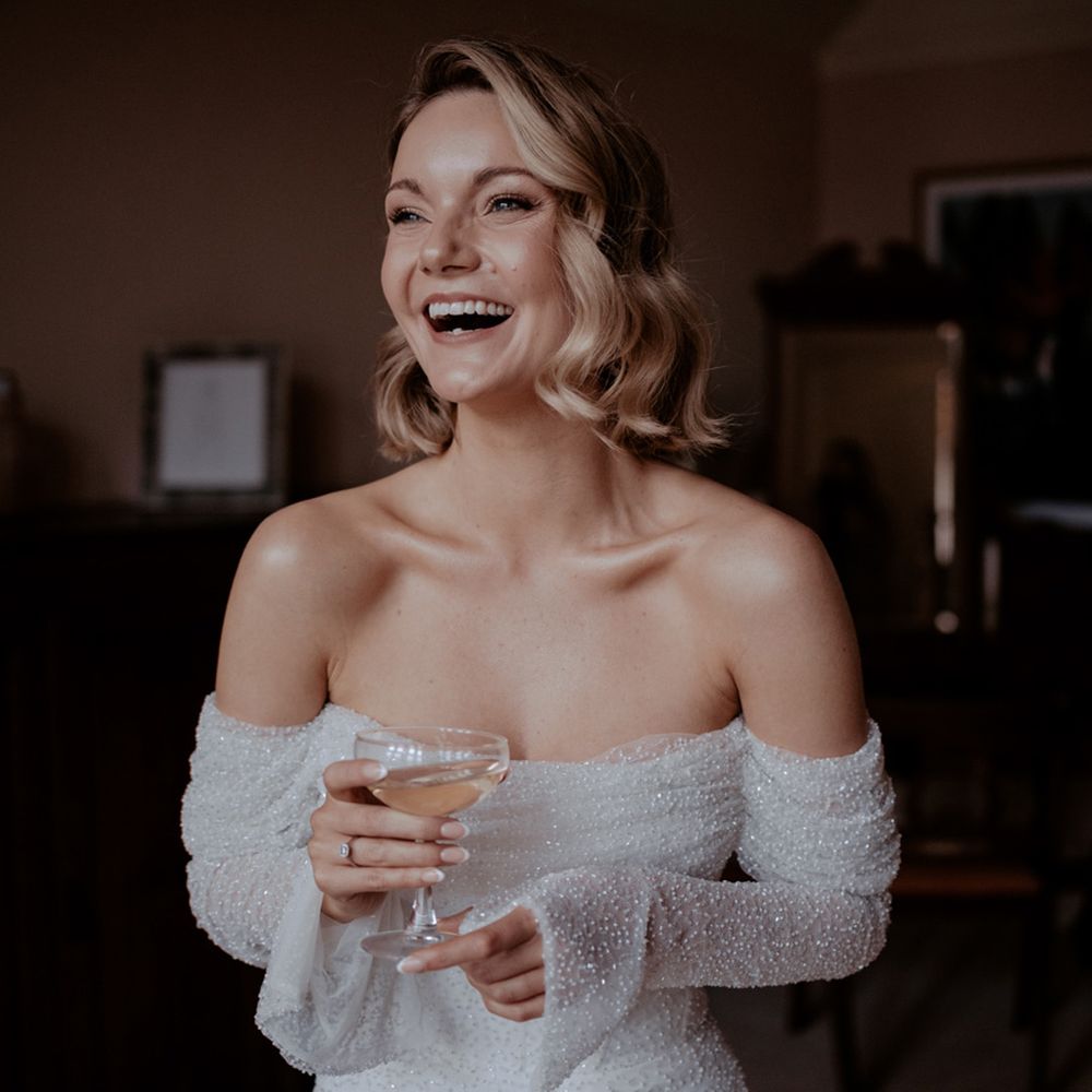 Bride in Emma Beaumont off the shoulder sparkly wedding dress for an old Hollywood glamour vibe 