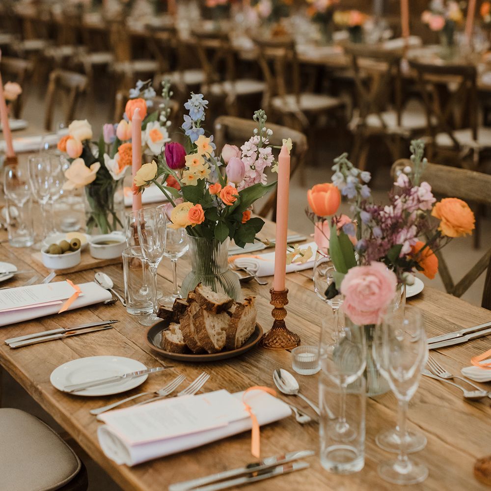 Pastel wedding table centrepieces on wood slice decor 