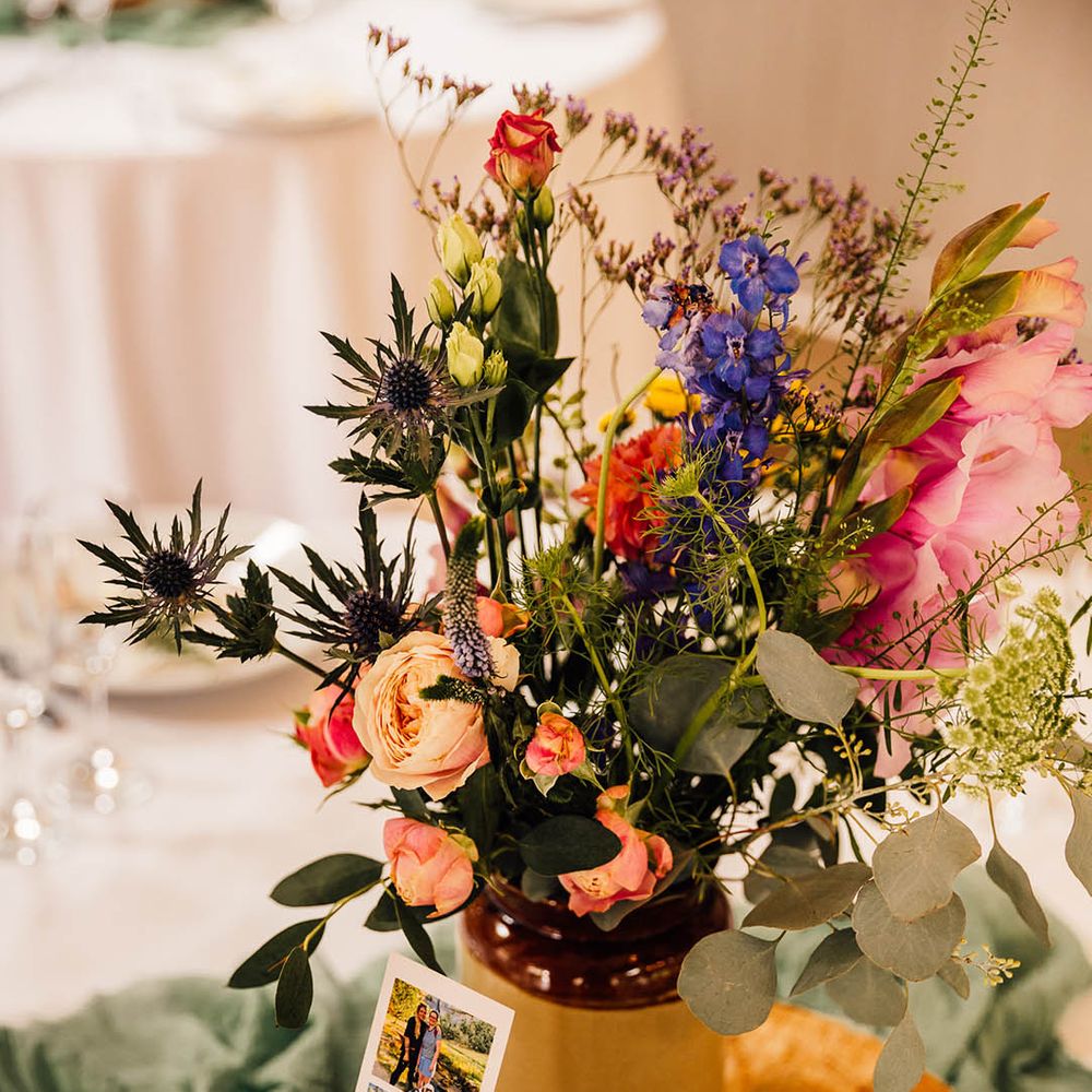 Wood slice wedding table decor and centrepiece with strip of photographs of the happy couple 