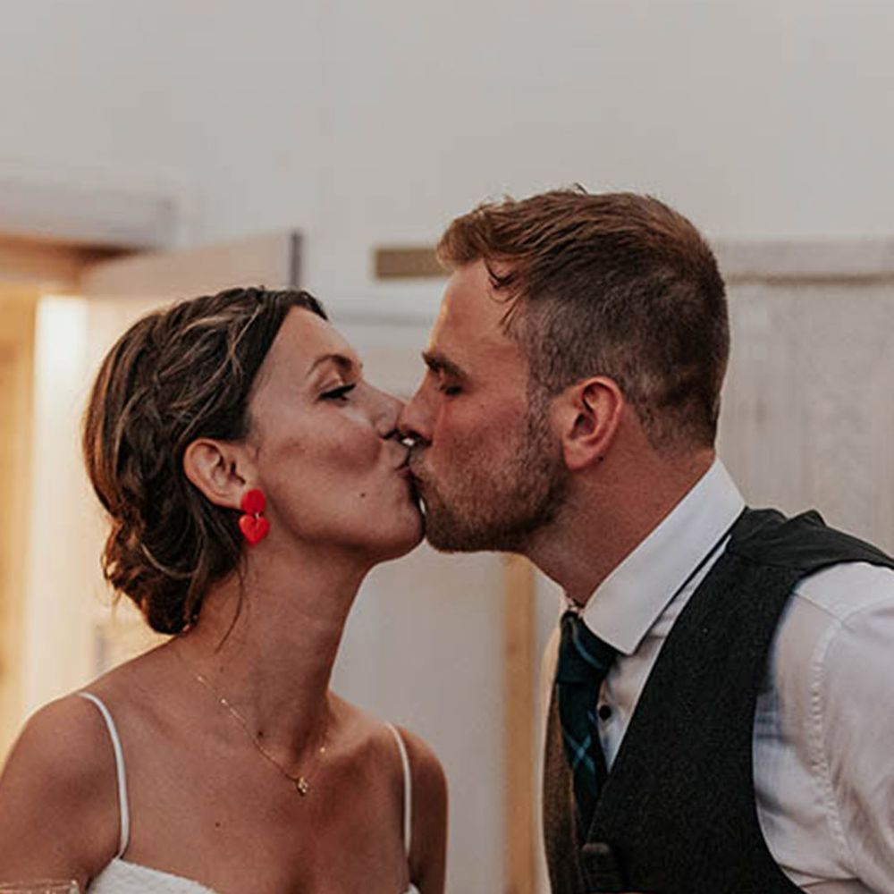 The bride and groom share a romantic kiss after their speech together 