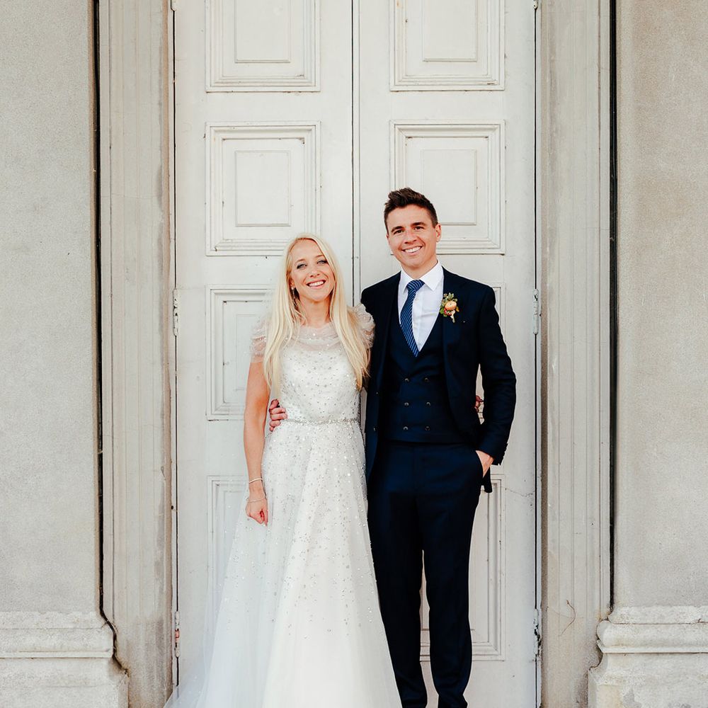 Bride wearing sparkly wedding dress from Jenny Packham with the groom wearing a blue wedding suit 