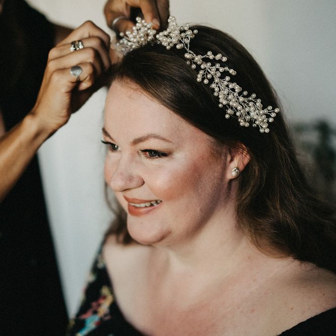 Bride having her hair accessories put in