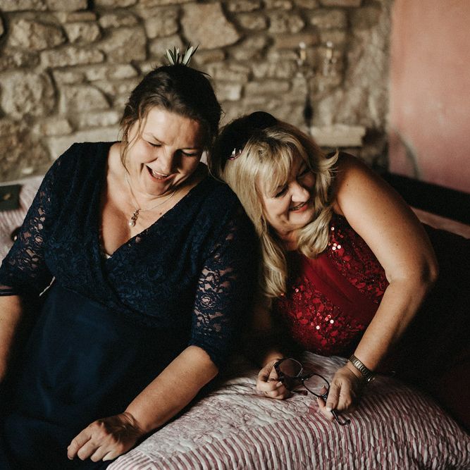Guests laugh, with olive boquet details in their hair