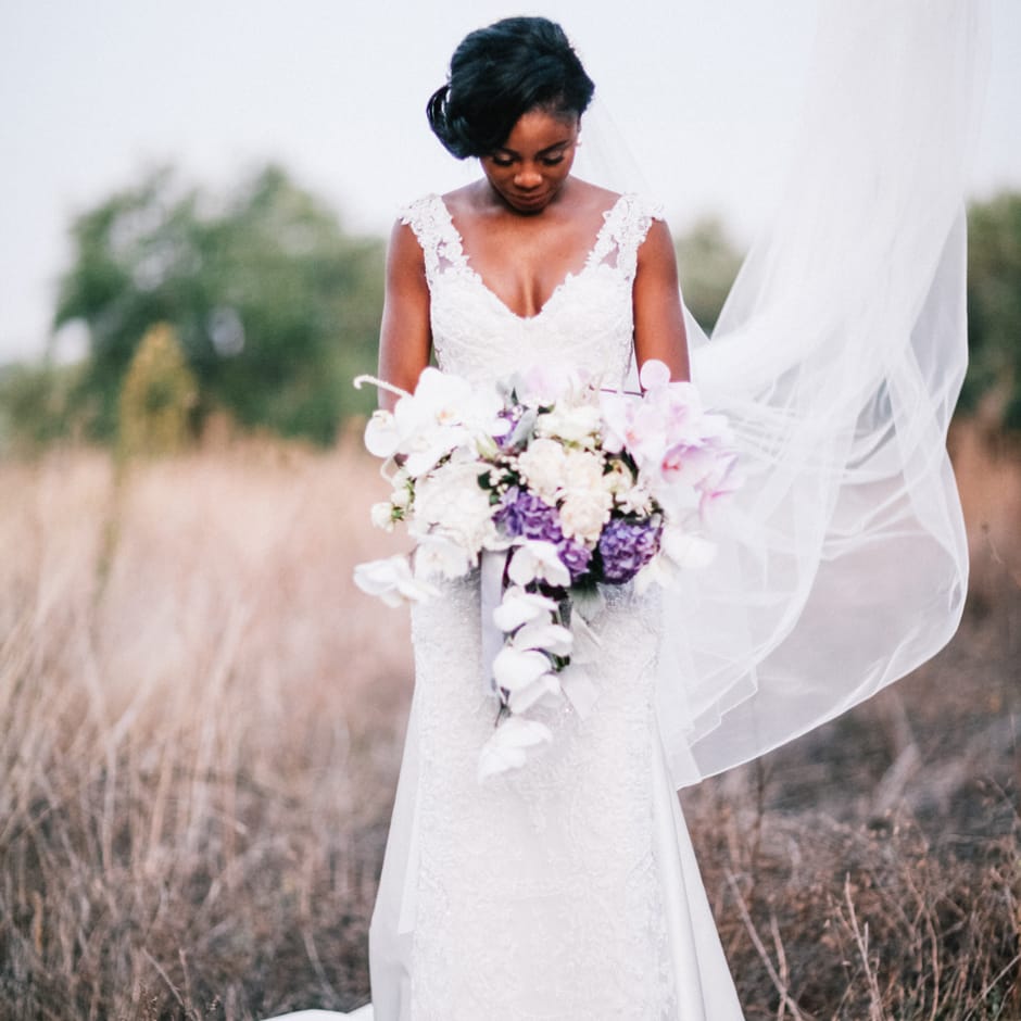 Beautiful black bride holding bridal bouquet for outdoor Italian wedding