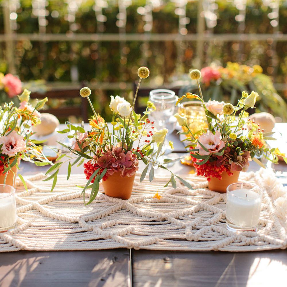Macrame wedding table decor with terracotta flower pots and candles