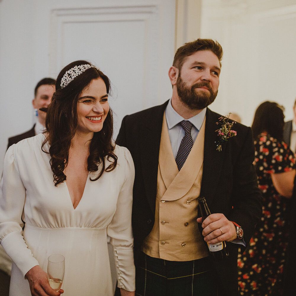 Bride and groom enjoying drinks with wedding guests 