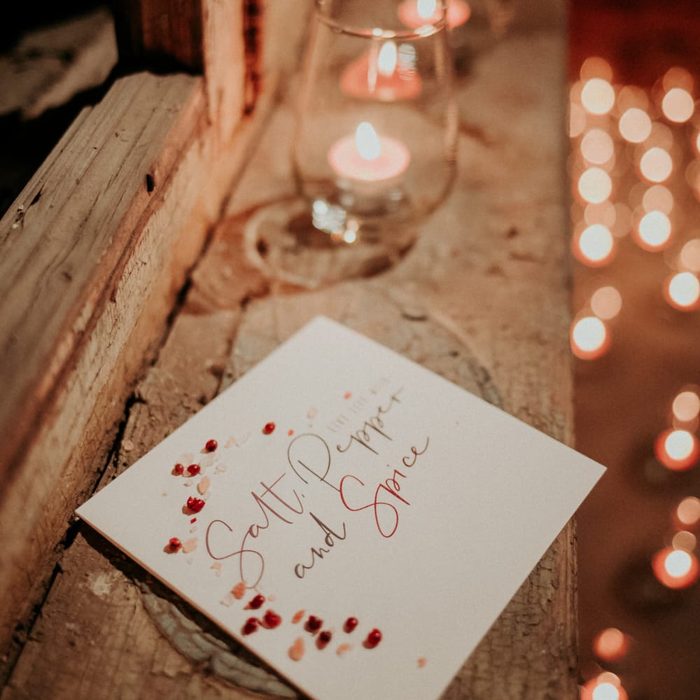Salt, pepper and spice wedding invitations with herbs and spices sprinkled inside
