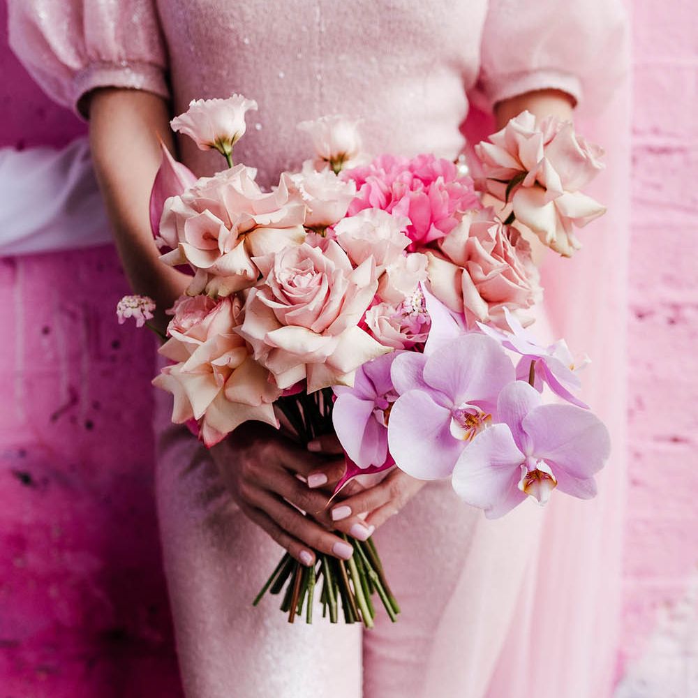 Pastel pink, lilac and fuchsia wedding bouquet with roses and orchid flowers 