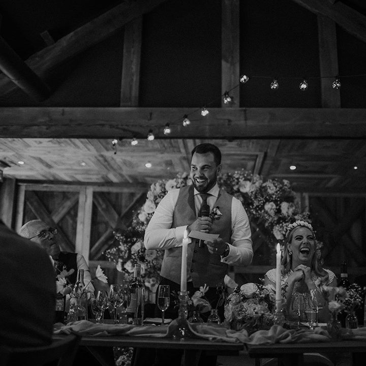 Groom in a waistcoat giving his wedding speech at Dewsall Court wedding reception 