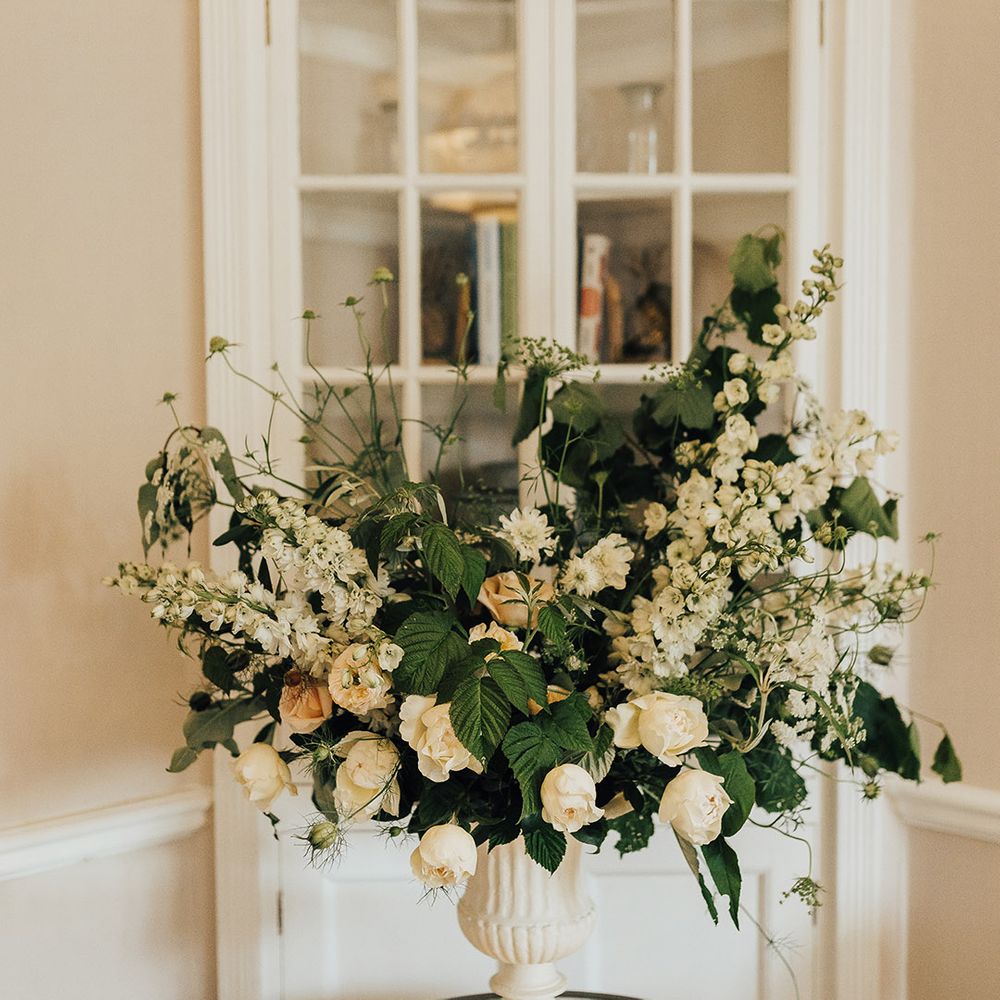 Romantic wedding flower arrangement with roses, stocks and foliage 