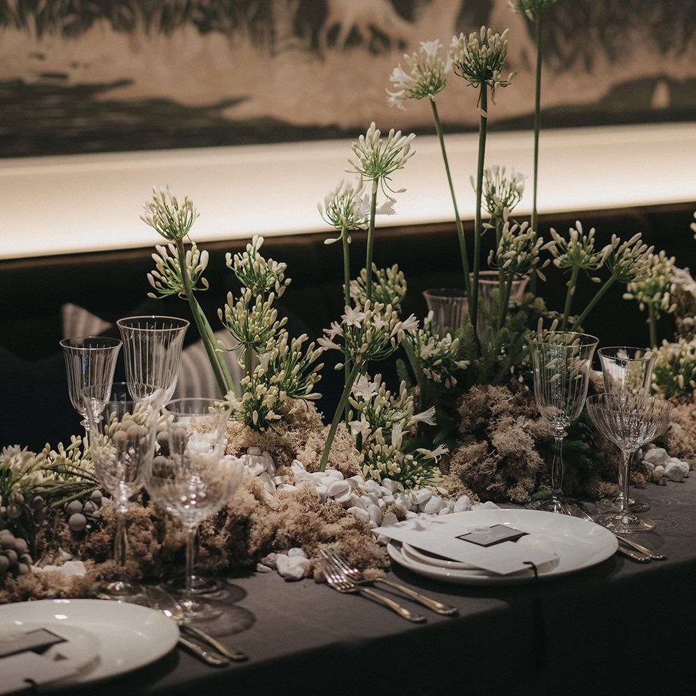 wedding table decor at Mayfair Townhouse with white alliums, pebbles and cut glass 