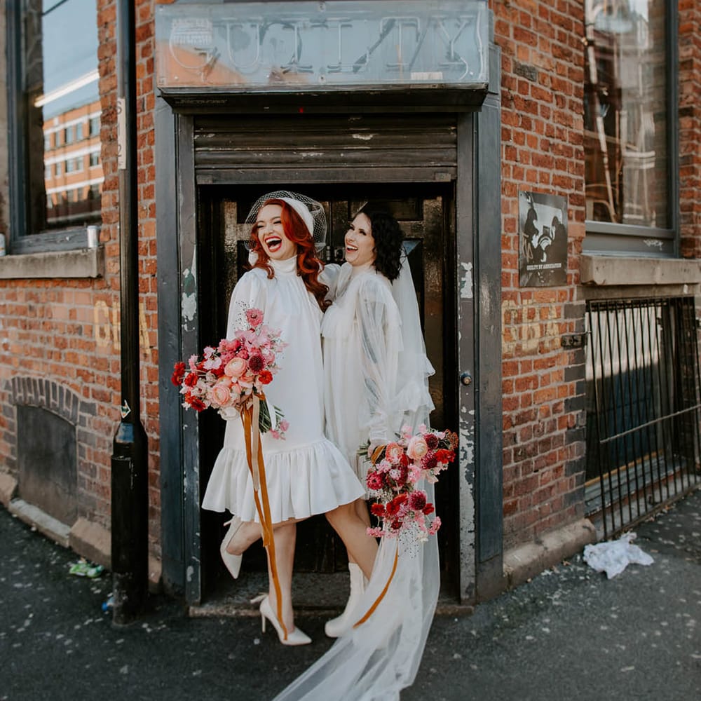 LGBTQI Mancester elopement with two brides in Moochild short wedding dress long veil and berret outfits 