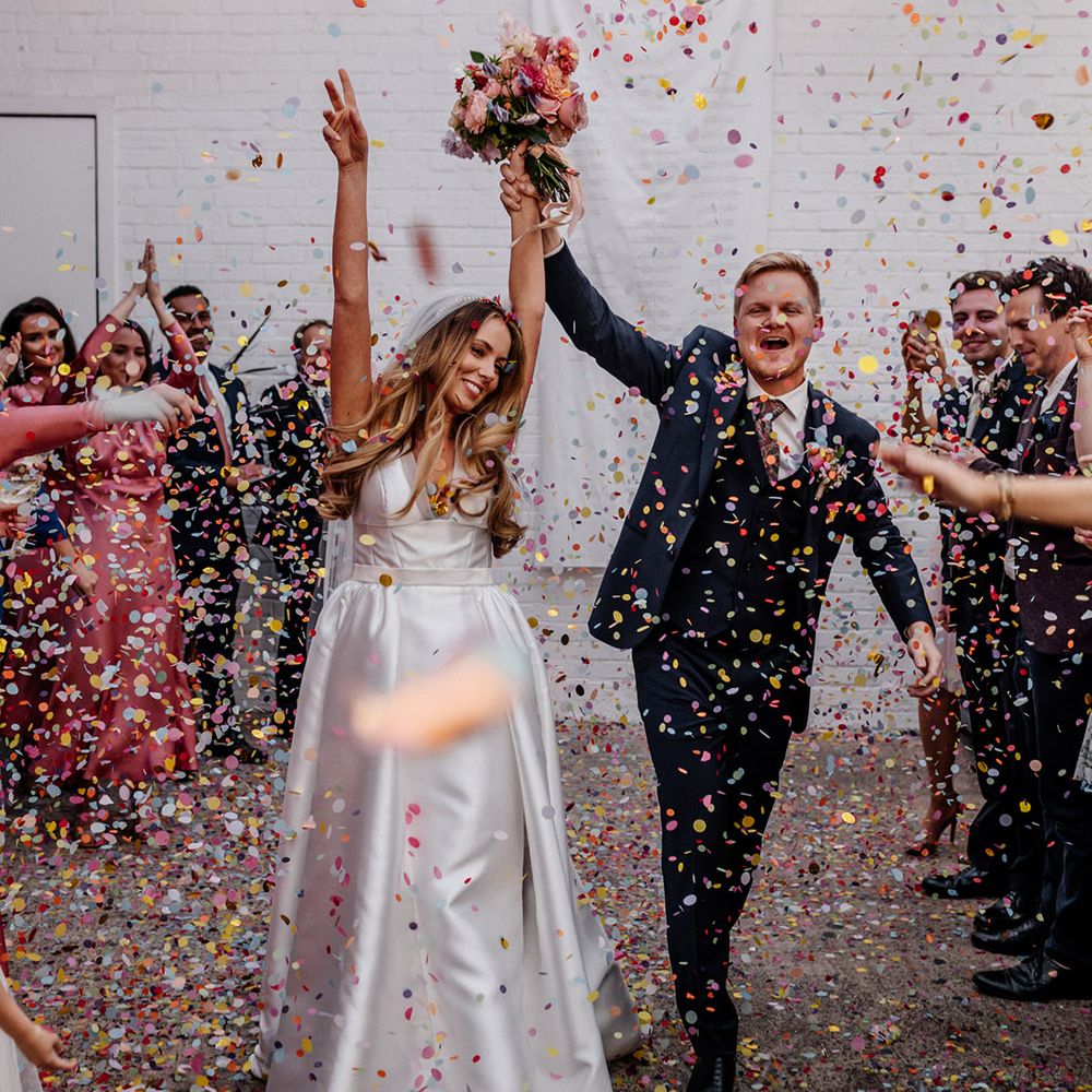 Colourful confetti moment at The Loft Studios London with the Bride in a Karen Willis Holmes wedding dress and the groom in a navy wool suit