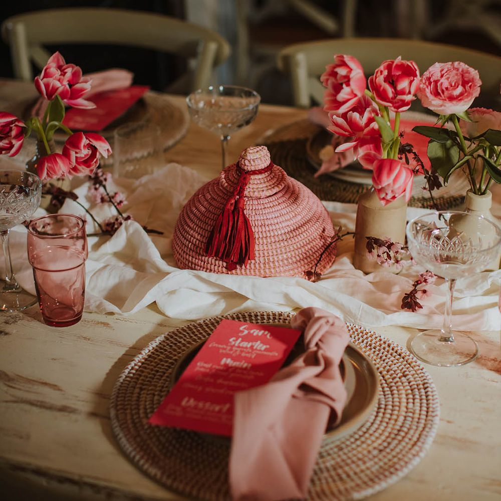 wicker place mat place setting with pink linen napkin and contemporary pink menu card wedding stationery