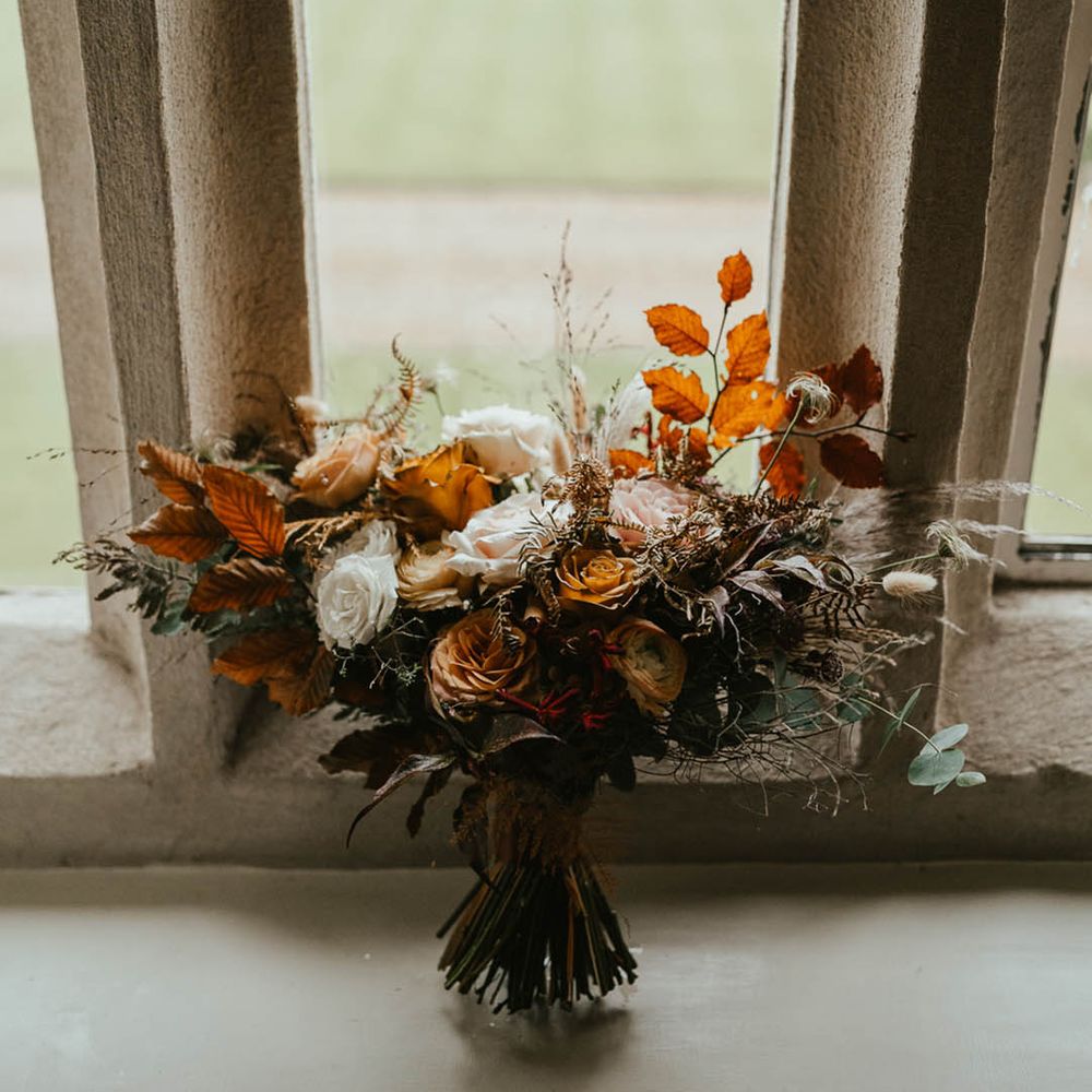 Rose wedding bouquet with autumn leaves for the autumn wedding at Oxnead Hall