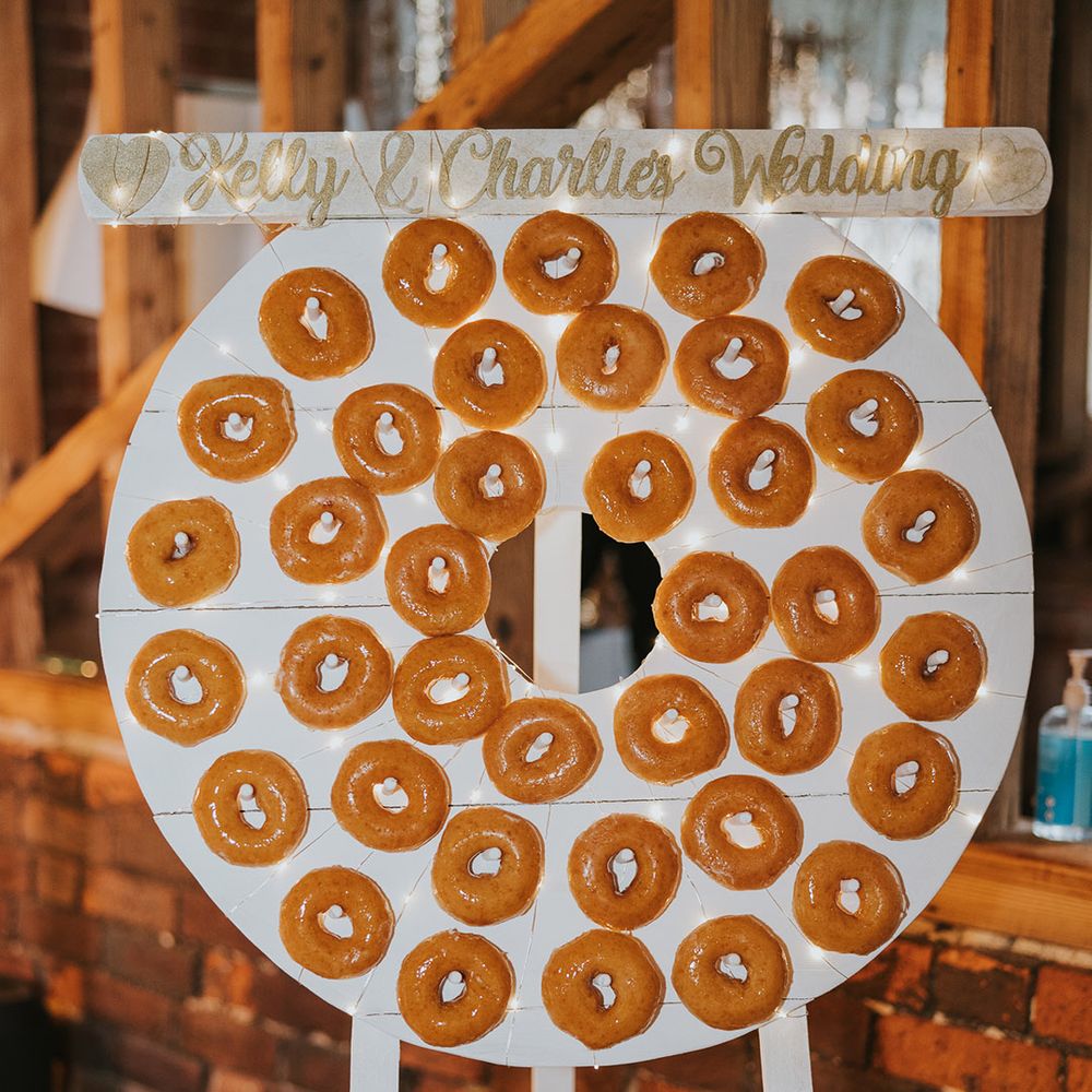 Circle doughnut wall with glazed doughnuts for wedding guests to enjoy 