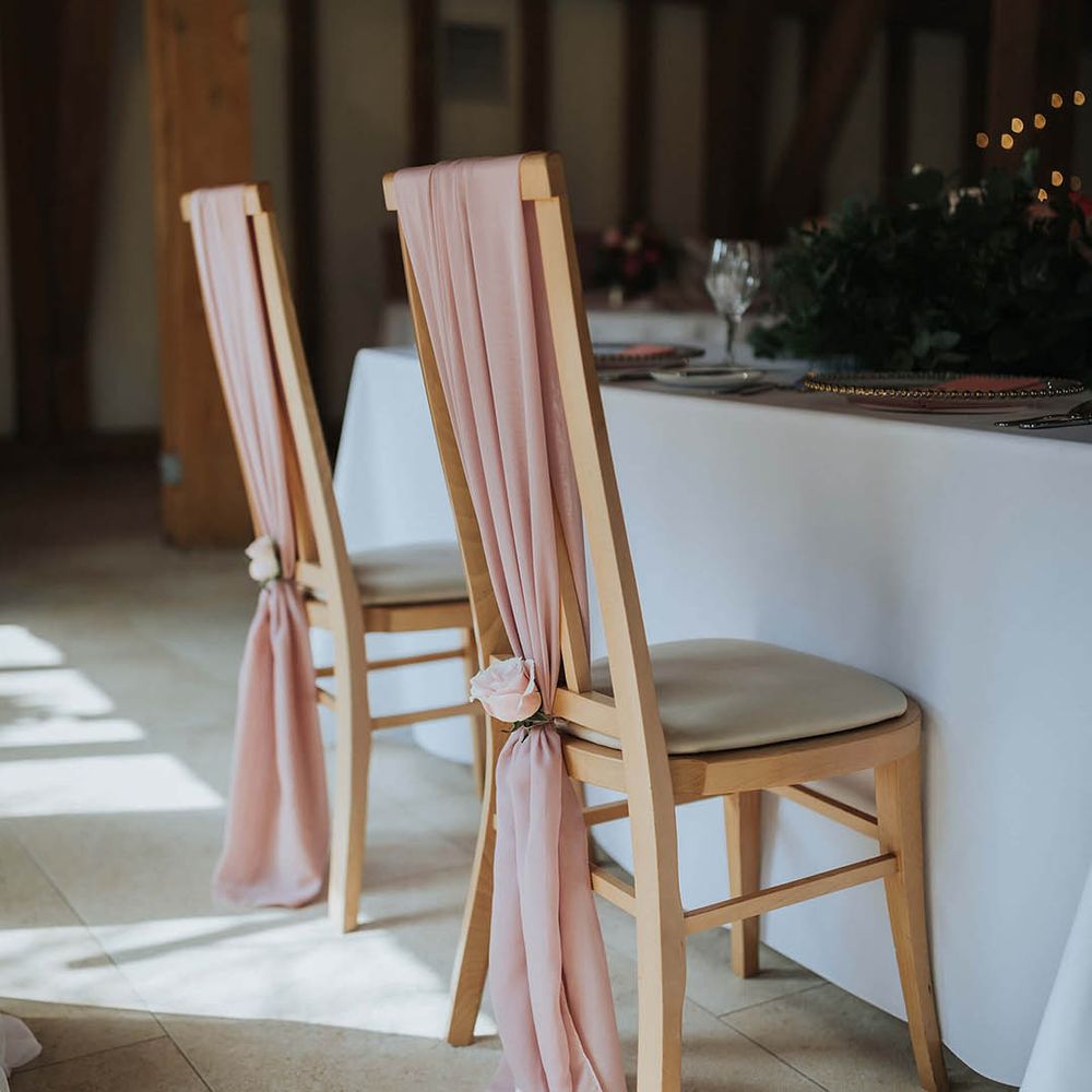 Pink material chair back decor with pink roses 