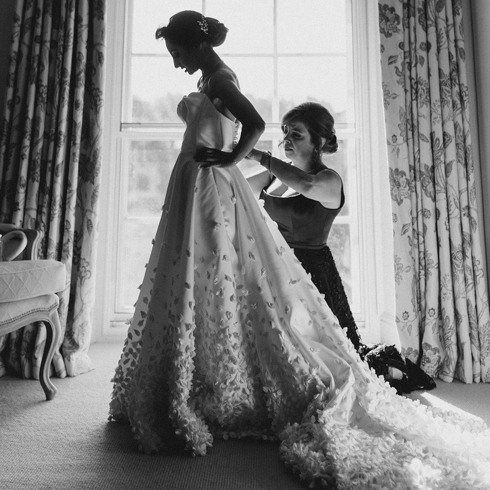 Bride wears bespoke Emma Beaumont design wedding dress with off the shoulder styling and embellished Princess skirt 